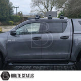 Black acrylic wind deflectors for Toyota Hilux 2015+ – complete front and rear set installed, reducing wind noise and rain while enhancing styling