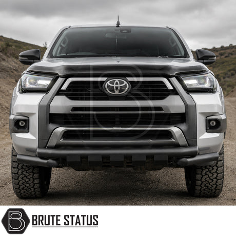 Front mounting heavy duty matte black powder coated nudge bar fitted to silver Toyota Hilux 2020+ pickup truck offroad 4x4 vehicle. 
