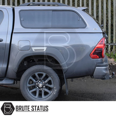 Toyota Hilux Invincible X Truckman GLS hardtop canopy with sliding, lockable windows, rear lamp, tow hitch, and Brute Status logo on the rear of the pickup truck.