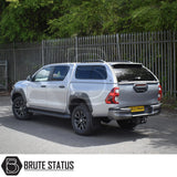 Toyota Hilux Invincible X 2016+ MK8, MK9 fitted with a Truckman GLS Hardtop Canopy, featuring remote locking and sliding windows, parked by a spiked-top fence.
