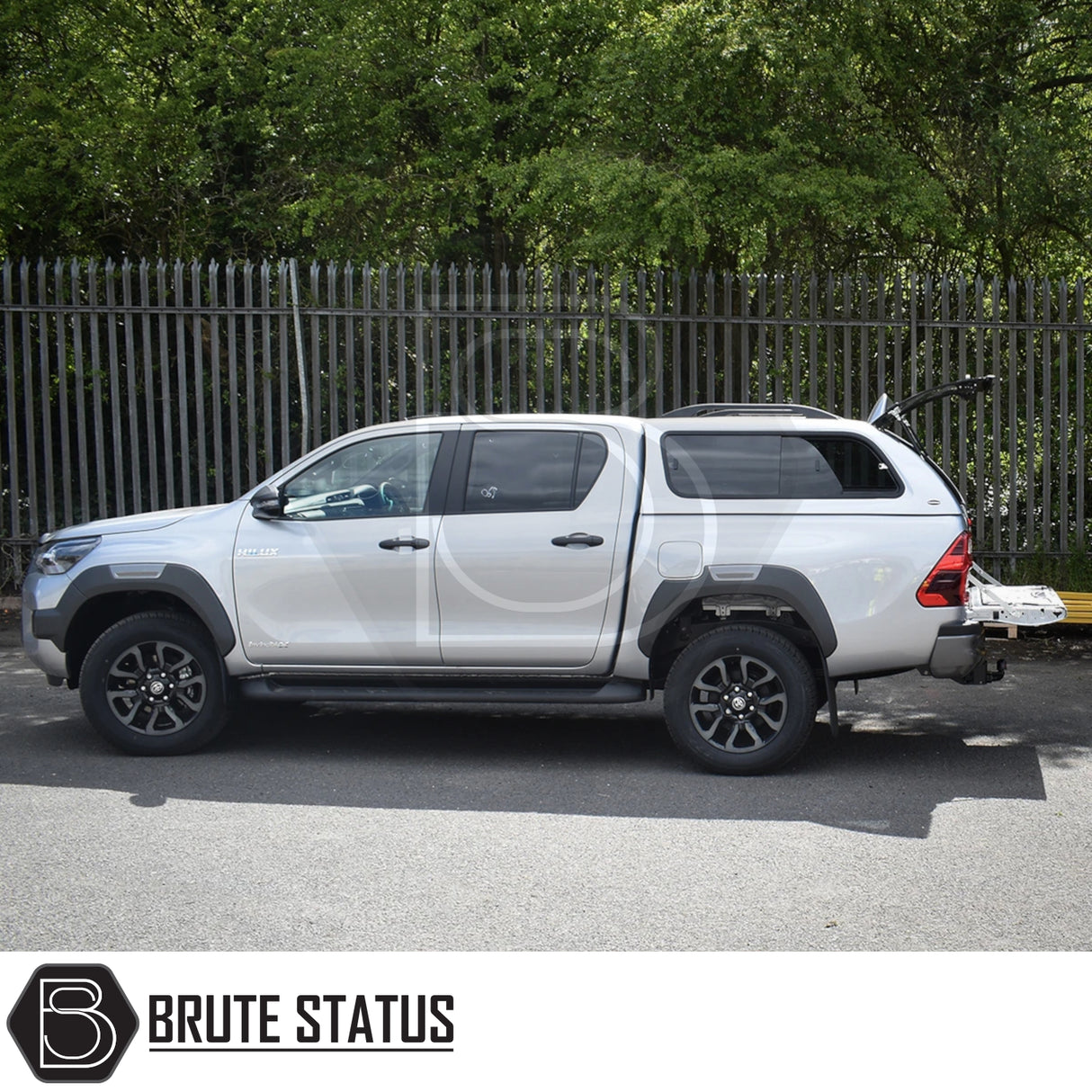 Toyota Hilux with Truckman GLS canopy, featuring remote locking and sliding windows, parked with open storage hatch showcasing Brute Status' aftermarket accessory.