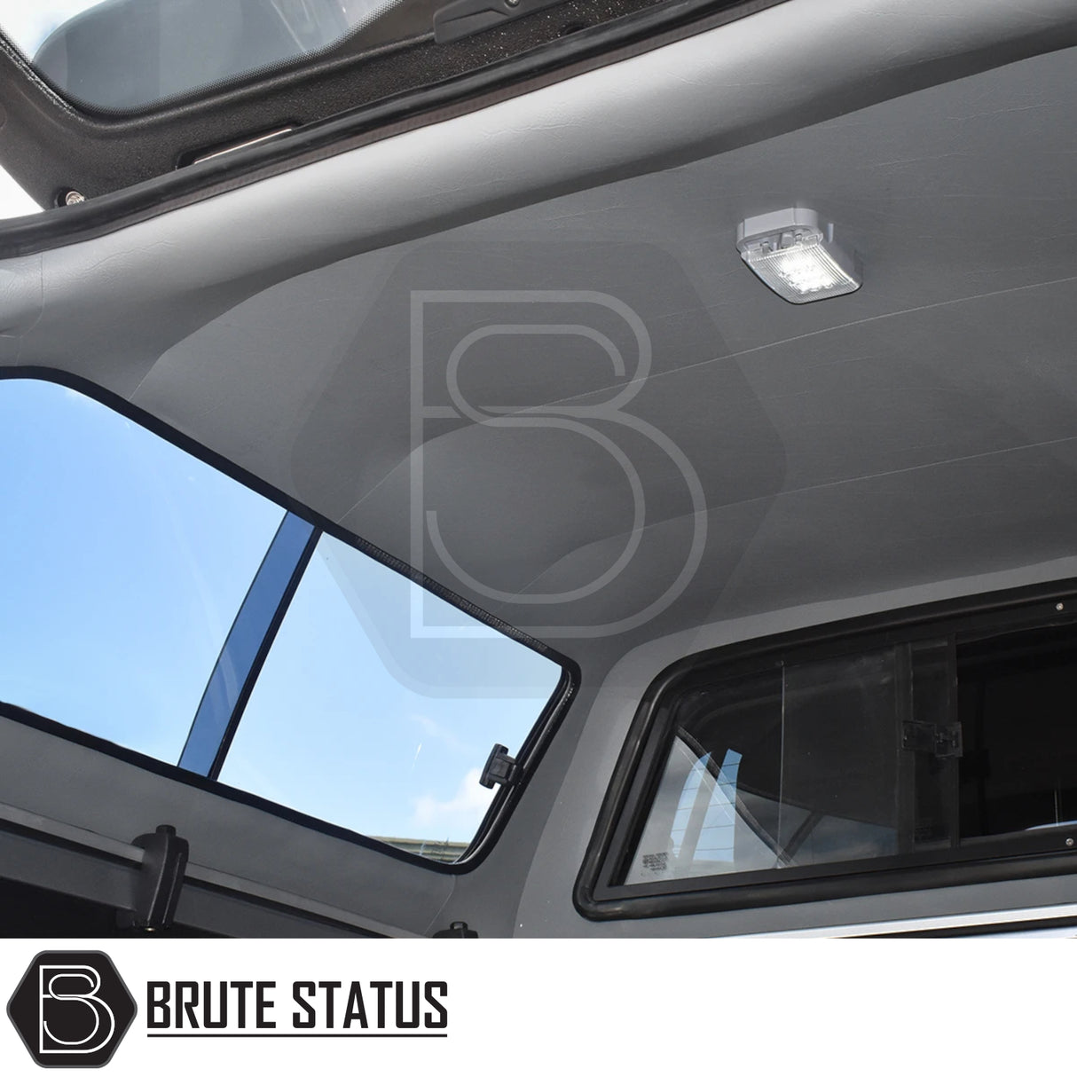 Interior view of Toyota Hilux Invincible X Truckman GLS Hardtop Canopy with grey headliner, LED light, pop-out side windows, and rear hatch supported by gas strut.
