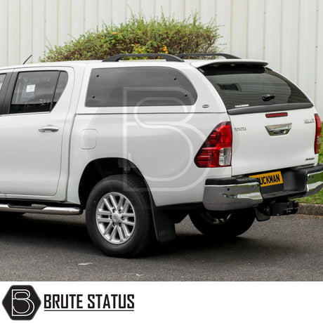 Rear view of Toyota Hilux with Truckman Grand Hardtop Canopy, featuring tinted side windows, roof rails, and chrome bumper, enhancing storage and security.