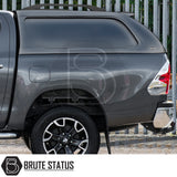 Toyota Hilux Invincible X Truckman L-Series hardtop canopy, rear view with alloy wheel, showing enhanced storage and security features, branded by Brute Status.
