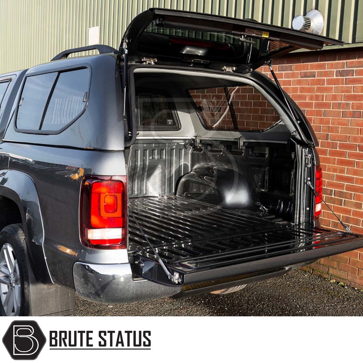 Volkswagen Amarok 2010-2022 Truckman GLS Hardtop Canopy with open tailgate and lifted hatch, showcasing empty ribbed steel cargo bed.