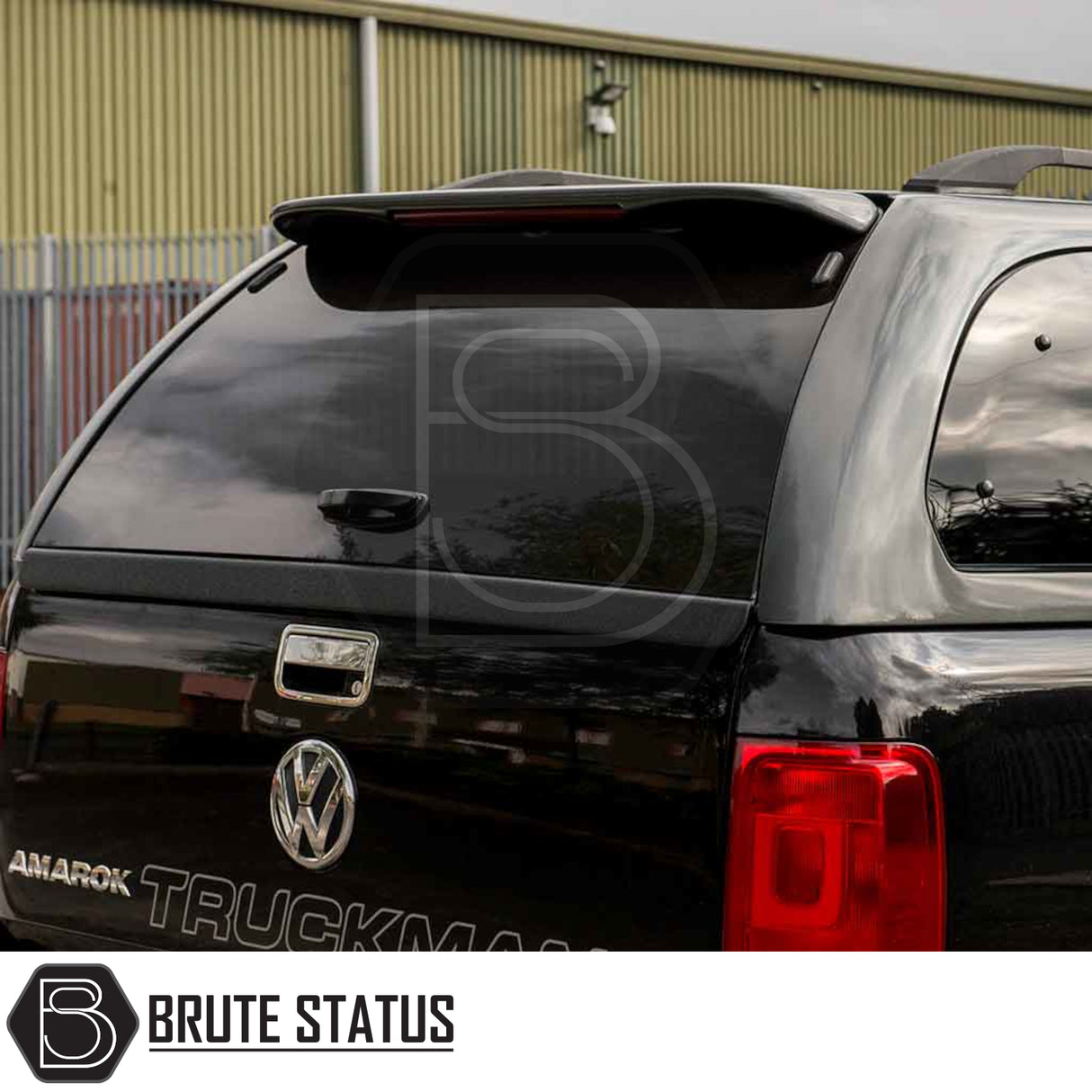 Volkswagen Amarok 2010-2022 Truckman Grand Hardtop Canopy with remote locking, featuring tinted rear window, roof spoiler, and “AMAROK” lettering, enhancing pickup functionality.