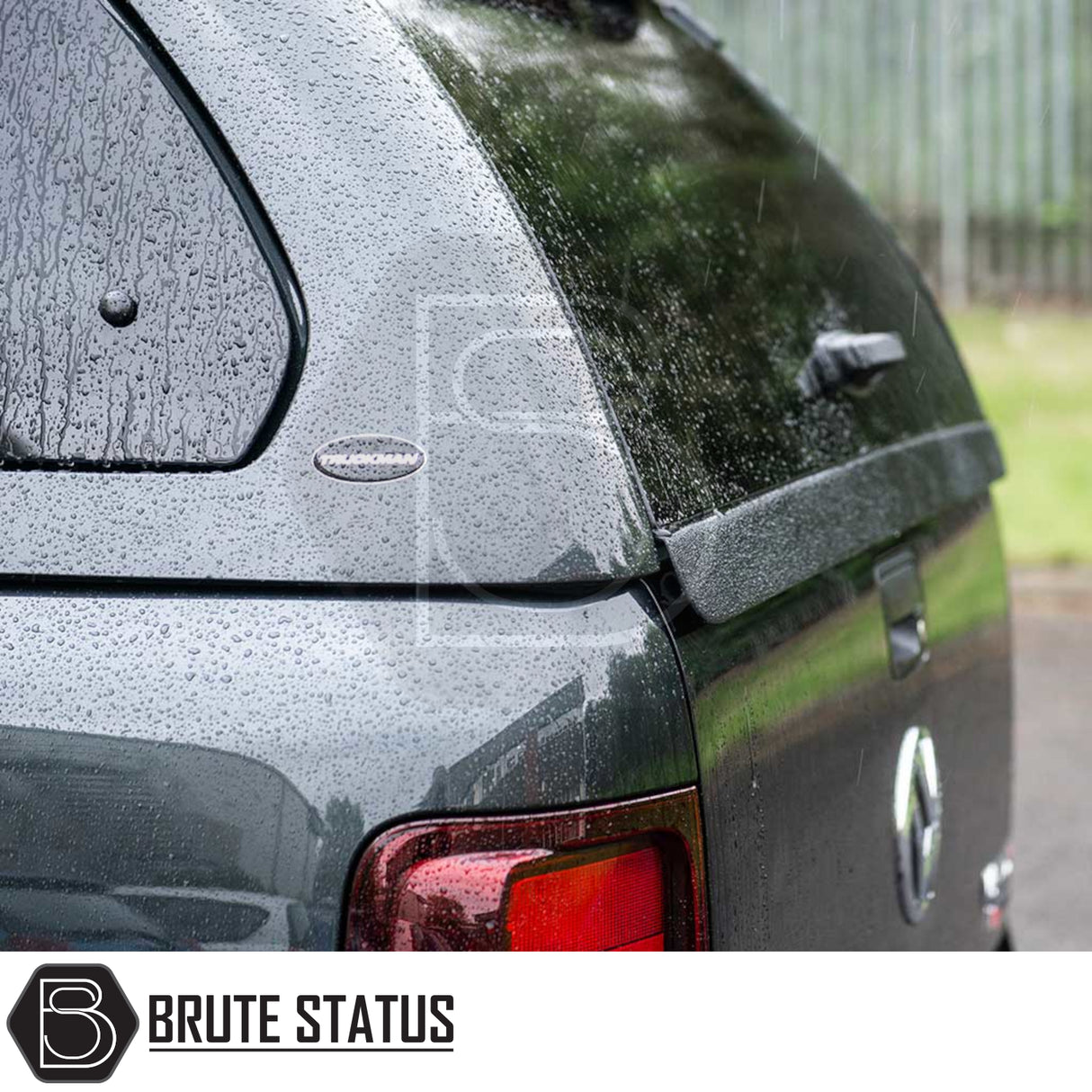 Volkswagen Amarok 2010-2022 Truckman Grand Hardtop Canopy with remote locking, featuring tinted pop-out windows and raindrop-speckled Brute Status logo.