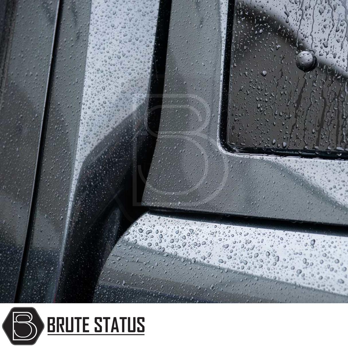 Close-up of matte-black metal panel with rain beads on Brute Status aftermarket armor for Volkswagen Amarok. Part of Truckman Grand Hardtop Canopy - Remote Locking.