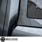 Close-up of matte-black metal panel with rain beads on Brute Status aftermarket armor for Volkswagen Amarok. Part of Truckman Grand Hardtop Canopy - Remote Locking.