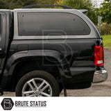 Volkswagen Amarok 2010-2022 Truckman Grand Hardtop Canopy features a cab-high design, tinted side windows, and roof rack rails, enhancing style and security.