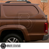 Volkswagen Amarok 2010-2022 Truckman L-Series Hardtop Canopy on metallic brown pickup, featuring Brute Status logo, smooth contoured side, alloy wheel, and secure, windowless design.