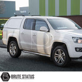 Volkswagen Amarok with Truckman L-Series Hardtop Canopy, featuring solid sides and alloy wheels, parked in front of an industrial building.