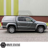 Volkswagen Amarok 2010-2022 fitted with Truckman RS Hardtop Canopy, featuring solid rear window and remote locking, parked by an industrial building.
