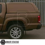 Volkswagen Amarok 2010-2022 Truckman RS Hardtop Canopy, featuring solid rear window and remote locking, shown on a brown pickup with alloy wheel and branded “Brute Status”.