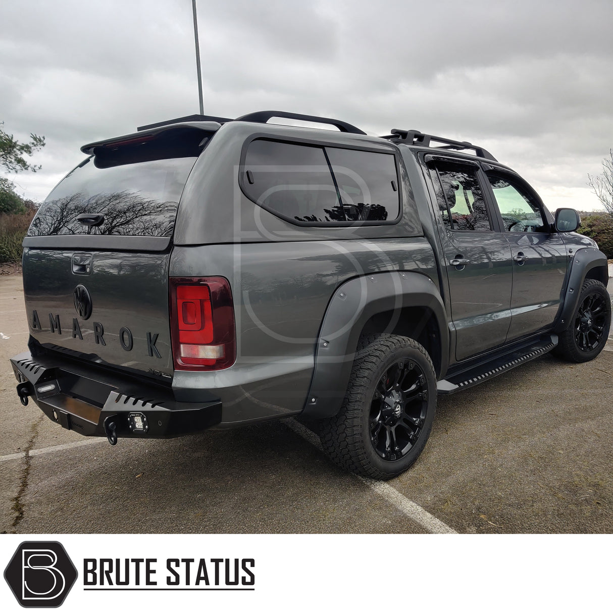 Matte black rear bumper for Volkswagen Amarok 2017-2022 with integrated lights and tow hitch compatibility