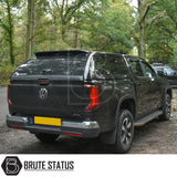 Volkswagen Amarok 2023+ Truckman Grand Hardtop Canopy, featuring remote locking, on a forest road. Fitted with aftermarket canopy and chrome bumpers.