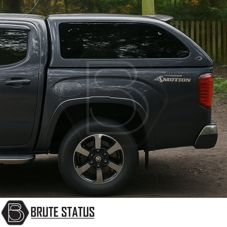 Volkswagen Amarok 2023+ Truckman Grand Hardtop Canopy with tinted windows and 4MOTION badge, showcasing premium rear design and alloy rim.