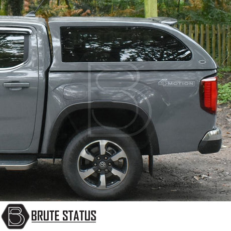 Volkswagen Amarok 2023+ Truckman Grand Hardtop Canopy with remote locking, showcasing rear quarter view with canopy, 4MOTION badge, wheel, and Brute Status branding.