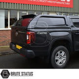 Black Volkswagen Amarok with Truckman L-Series hardtop canopy, featuring remote locking and tinted windows, displayed at Brute Status, the UK's largest hardtop manufacturer.